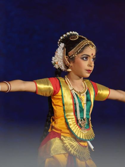 A close-up of a young performer, her arms outstretched with perfect form. Her dedication shone through in her award-winning performance.