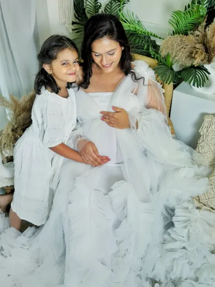 A beautiful portrait of a mother-to-be and her daughter sharing a quiet moment. Including older siblings in maternity shoots makes them feel part of the special journey.