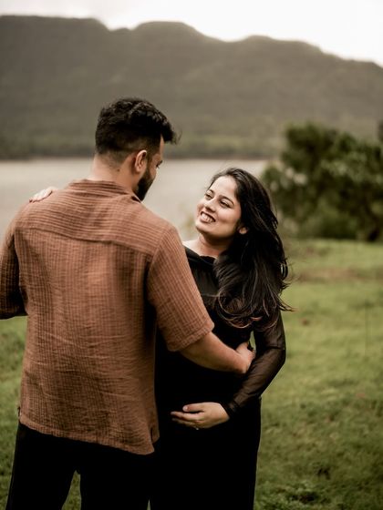 A beautiful portrait of the couple looking at each other, framed by the lake and hills behind them. It’s a quiet, loving moment that speaks volumes.
