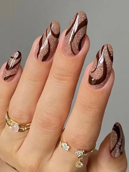 A unique design combining a shimmery brown base with dark chocolate brown swirls. The glitter base adds depth and a touch of glamour to the abstract art.