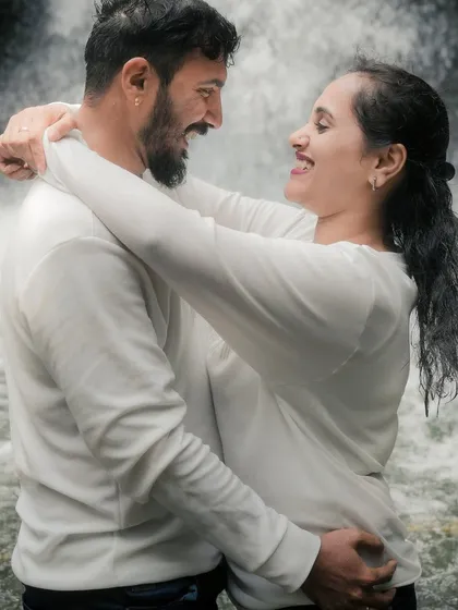 A purely joyful and candid moment of laughter between the couple, with a waterfall in the background. These are the unposed, real memories that I strive to capture.