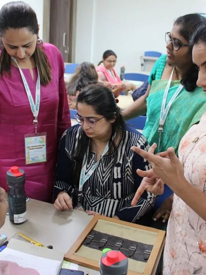 A close-up of trainees mastering the use of a Montessori material. Every piece of apparatus has a specific purpose, and our course ensures you learn the precise presentation for each one, from Exercises of Practical Life to advanced language and math materials.