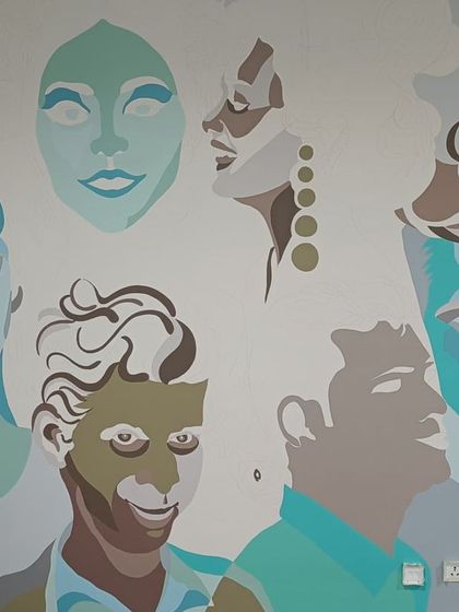 The mural taking shape as more faces and details are added.