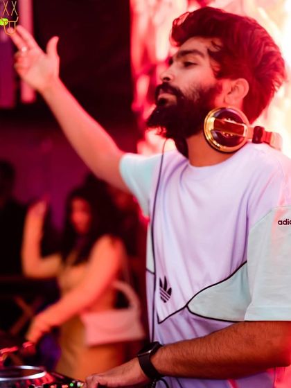 A shot of me at The Fixx Bar, with my signature gold headphones, getting ready to drop a beat.