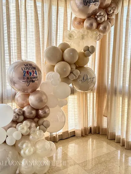 A beautiful, organic balloon garland in a sophisticated neutral palette. These arrangements can be customized to fit any space or occasion.