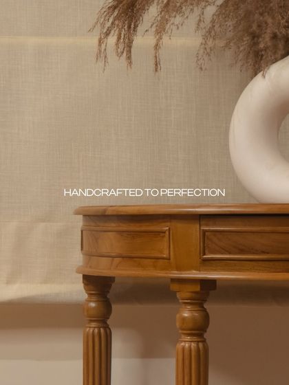 A detail of the console table, handcrafted to perfection. The turned legs and rich teak wood add a touch of sophistication and timeless beauty.