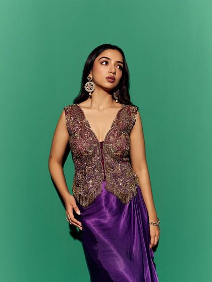 A poised, elegant shot that highlights the structure and fit of the embroidered vest. This angle provides a clear view of the garment's silhouette for the e-commerce listing.
