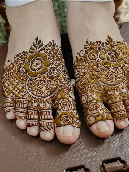 Your feet deserve some love too. This is an example of a detailed floral mehendi design for the feet, covering the toes and top of the foot for a beautiful, complete look.