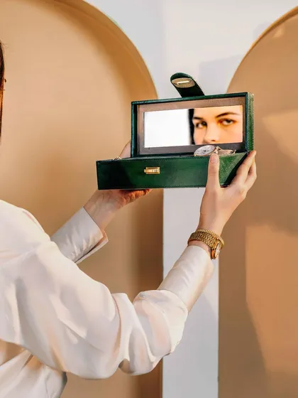An artistic and creative shot for Verman Atelier, capturing a model's reflection in the mirror of a jewelry box. This image is both a product shot and a conceptual portrait, adding a layer of intrigue.