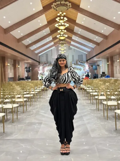 Posing in the center of the empty reception hall, capturing the scale and elegance of the venue before the party starts.