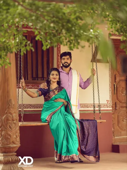 A charming portrait of a couple on a traditional swing, perfectly capturing a blend of culture and romance.