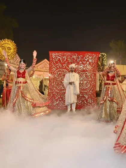 An amazing and jaw-dropping groom entry. Dancers in shimmering traditional attire perform amidst a cloud of smoke, their movements synchronized to create a path for the groom.