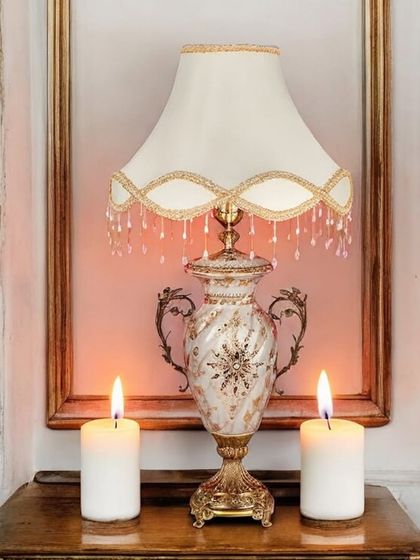 Placed between two candles, this Victorian lamp creates an incredibly warm and romantic ambiance. The marble-effect finish on the porcelain base and the classic fringed shade make it a perfect fit for a traditional or glam interior.