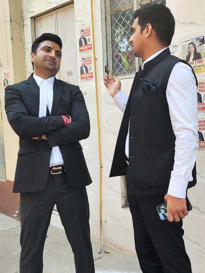 In discussion with a colleague against a backdrop of campaign posters.