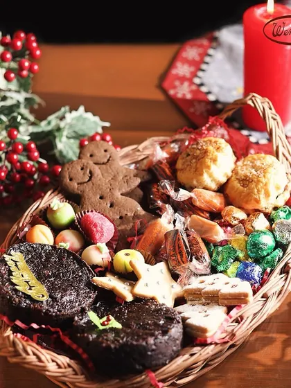 When the festive season arrives, so do our special Christmas hampers. This wicker basket is brimming with our holiday best, from rich plum cake and gingerbread men to marzipan candies and assorted chocolates.