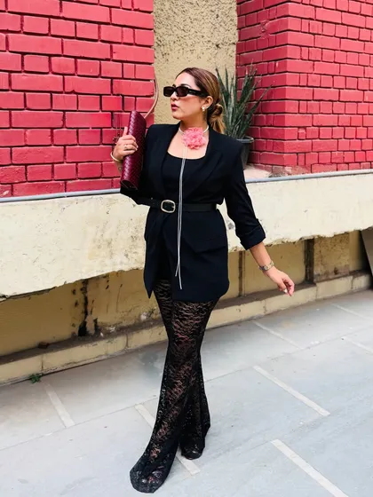 Walking with confidence in this edgy yet chic outfit. The combination of classic black with pops of color and texture makes it a memorable and high-fashion look.