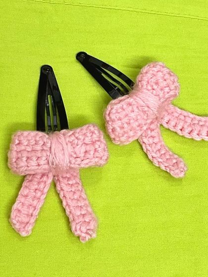 A pair of my pink crochet bow hair clips. These are attached to simple snap clips, making them easy to put in and take out.