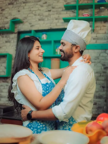 Love is cooking up something beautiful! This couple shares a laugh in a quirky kitchen setting, a perfect example of a themed pre-wedding shoot that reflects shared interests and creates fun, natural interactions.