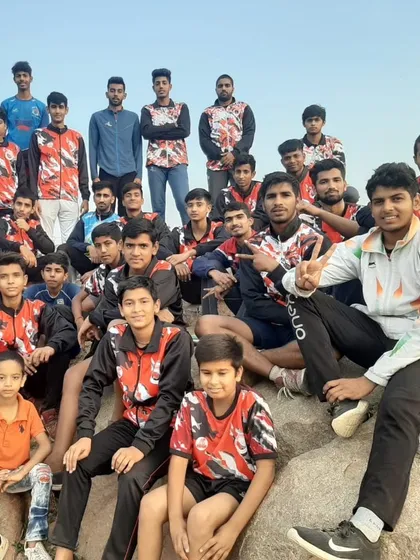 The whole team enjoying some downtime together on a rocky outcrop during an outdoor trip.