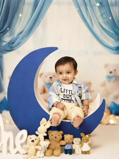 Before the cake smash, we always take some clean portraits. This little boy looks so cute sitting on our moon prop, part of the 'twinkle twinkle little star' theme.