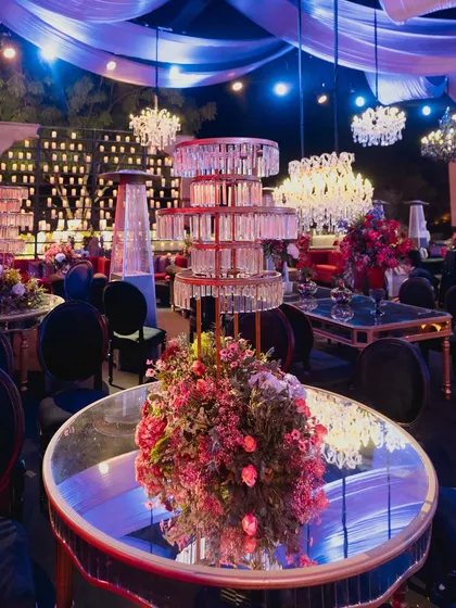 A glamorous reception setup with mirrored tables, crystal chandeliers, and towering candle walls, creating an atmosphere of pure opulence and romance.