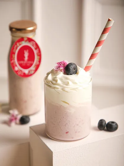 Our beautiful blueberry smoothie, topped with whipped cream and a fresh berry. A refreshing and healthy treat.