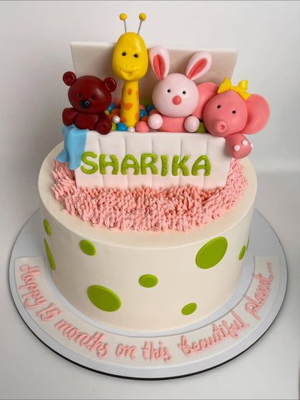 A full view of the toy box cake, personalized with the name "Sharika" and a sweet message around the base.