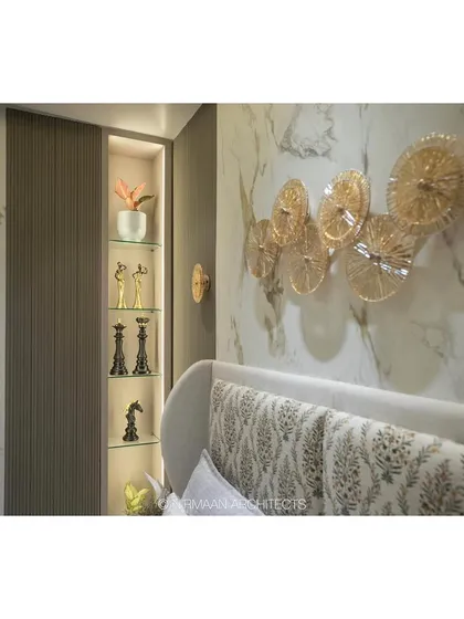 Detail of the master bedroom in the Duplex Project. The built-in, lit display niche next to the bed is perfect for showcasing personal treasures, while the patterned headboard adds a touch of traditional elegance.
