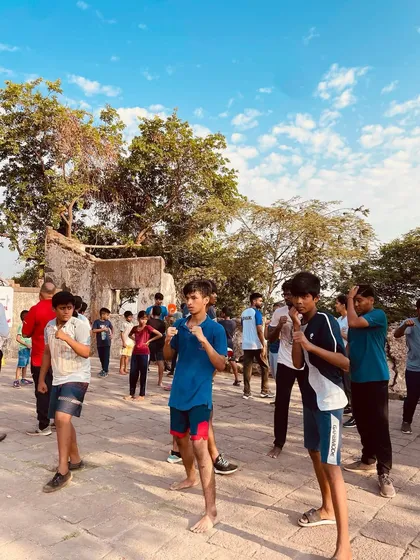 A group of young participants learning the basic fighting stance at our free kickboxing camp. We focus on building a strong foundation, teaching proper form and balance from the very first lesson.