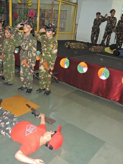 Students dressed as soldiers from the Indian Army salute the flag during a powerful skit for the Independence Day celebration.