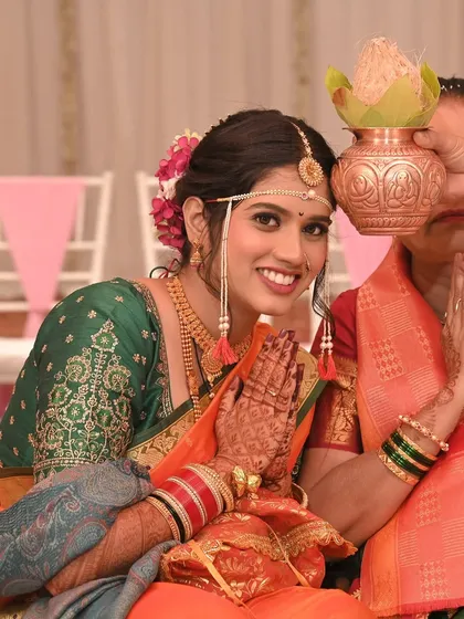 A beautiful smile from the bride as she receives blessings. Her makeup is fresh and radiant, perfect for the daytime ceremony.
