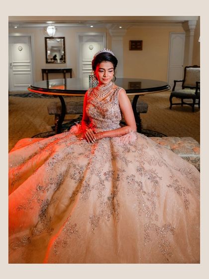 The bride looks like a modern-day princess in her stunning silver-embroidered ball gown. This portrait captures her elegance and poise in a quiet moment before the reception festivities begin.