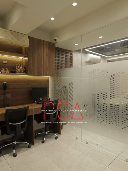 A wider view of the workstation area, showing the relationship between the open desks and the glass-enclosed meeting spaces.