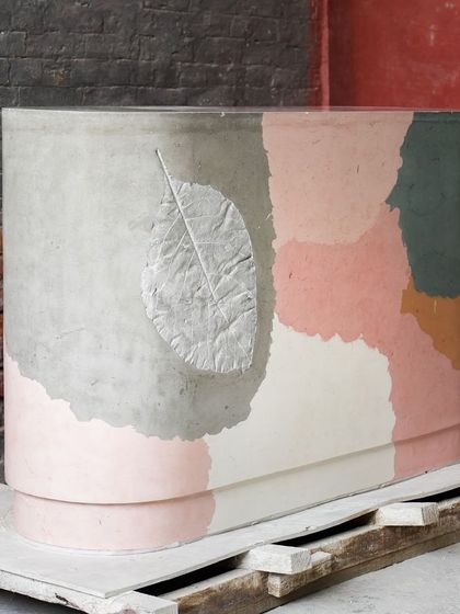 Another view of the custom bar table, highlighting the elegant curve of the counter and the beautiful blend of pastel colors. The leaf imprint adds a subtle, organic detail.