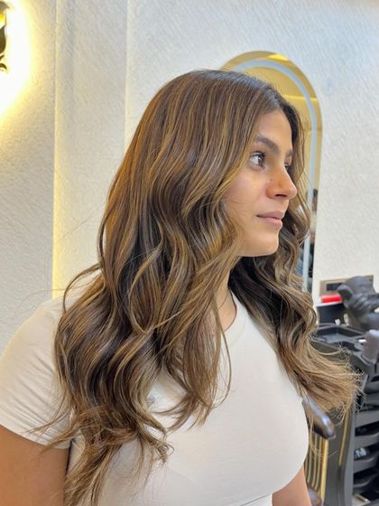 A side profile of the beige ashy brown hair colour. The light catches the ashy tones, creating a beautiful, modern effect.