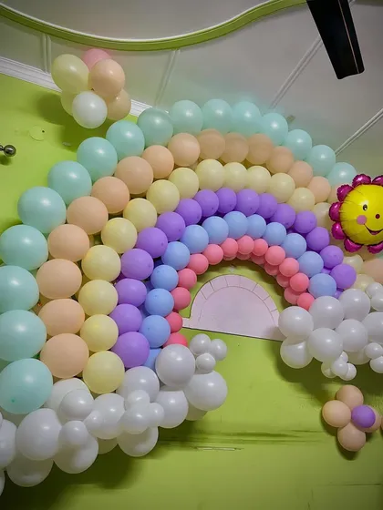 A wide shot of the beautiful rainbow balloon creation.