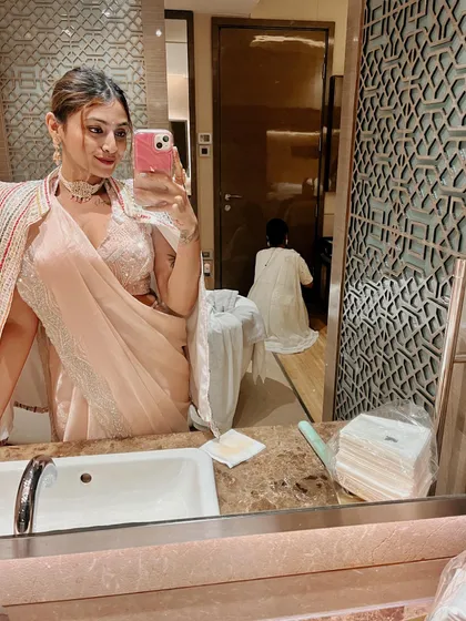 A behind-the-scenes mirror selfie while getting ready. Even in the middle of the chaos, it's fun to capture the process of putting together a festive look.