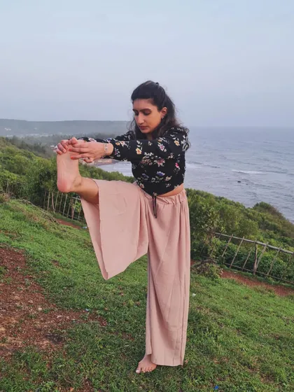 Practicing a standing leg stretch by the sea. The sound of the waves and the fresh ocean air make for a deeply grounding and balancing yoga session.