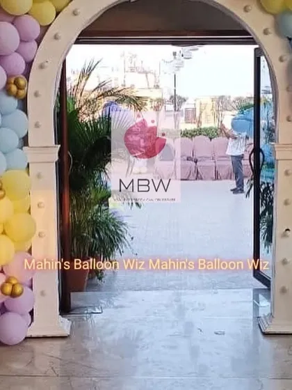 The grand entrance to the Bluey party, featuring a custom-built arch decorated with matching pastel balloons.