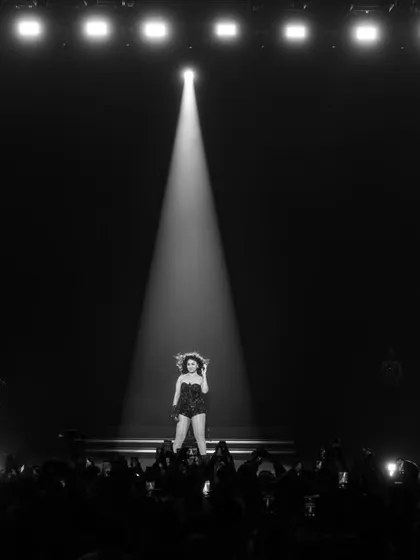 One artist, one spotlight, one massive arena. This black and white shot highlights the sheer scale and focus of our productions.