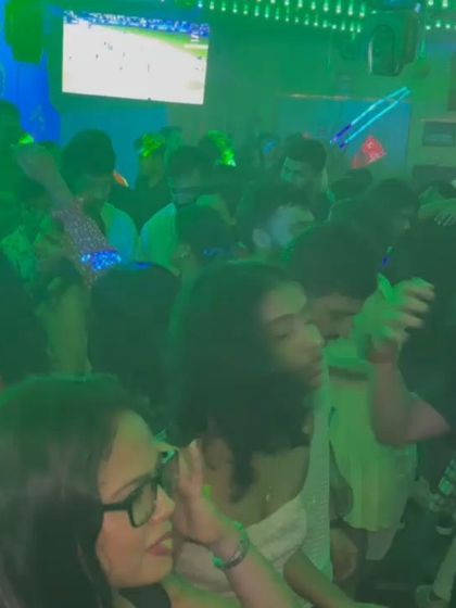 A candid shot of the crowd dancing and enjoying the music under the club lights.