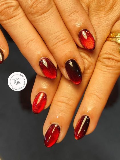 Another view of the red cat-eye nails. This look is bold, dramatic, and perfect for the festive season or a night out.