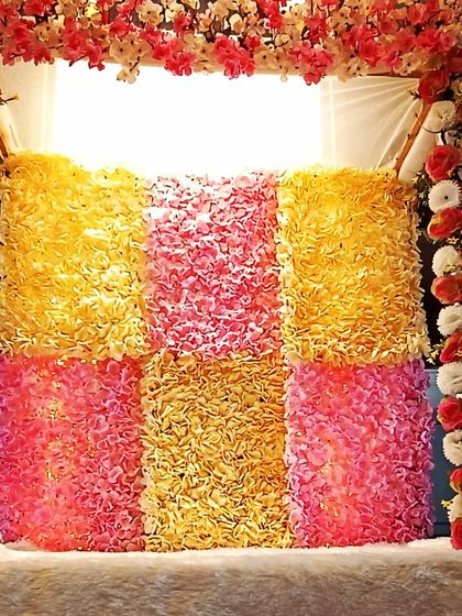 A closer look at the textured floral backdrop for the Ganpati mandap. The mix of colors and flowers creates a rich and festive look.