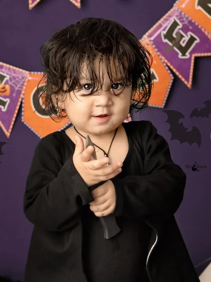 A close-up of a little vampire's intense gaze. The costumes and simple props make these Halloween portraits so much fun.