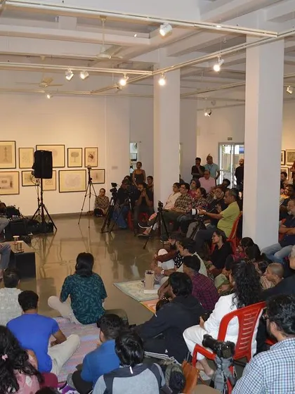 Another angle of the artist talk, showing the large and engaged audience.