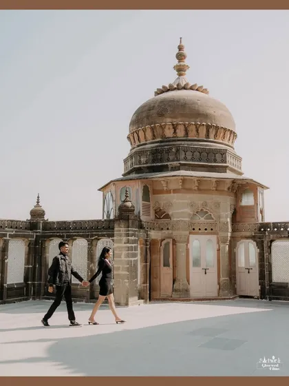 We create timeless portraits against backdrops of history and grandeur. At the magnificent Vijay Vilas Palace, we captured this couple walking hand-in-hand, their modern love story framed by the palace's majestic architecture.