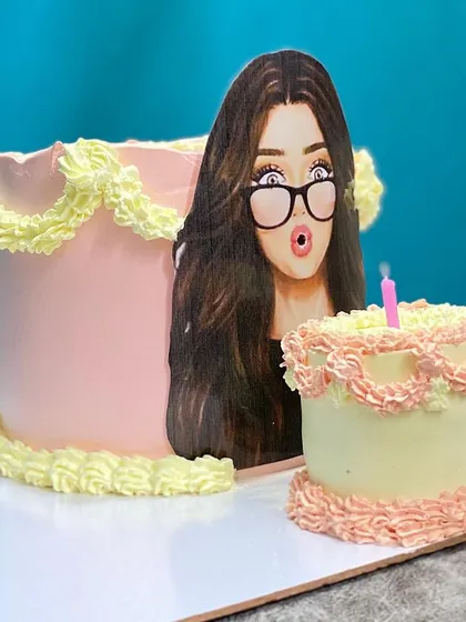 A side view of the blow-out cake, showing the main cake and the mini "candle" cake.