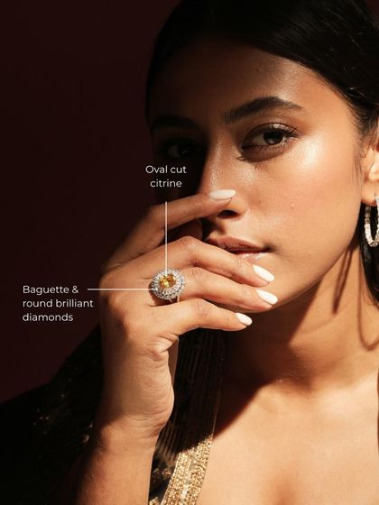 The Golden Halo Ring, featuring a sunny oval-cut citrine surrounded by a halo of baguette and round brilliant diamonds. This piece exudes warmth and sophistication.