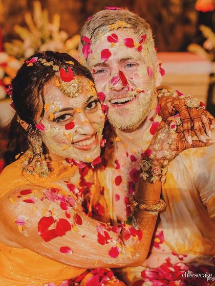 A beautiful portrait of the couple embracing amidst their colorful and joyous Haldi celebration.