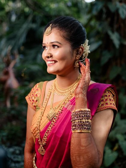 A smiling portrait of Sushma. Her HD makeup looks fresh and radiant, perfect for capturing the joy of her special day.